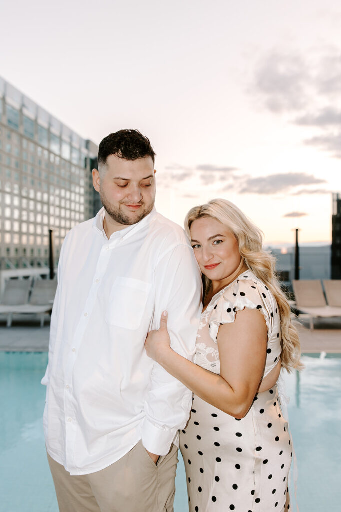 Couple laughing and holding hands on the rooftop lounge of the Omni Hotel Seaport.