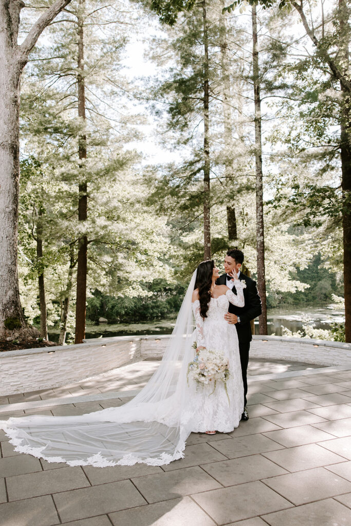 bride and groom smiling at eachother posing at lakeview pavilion