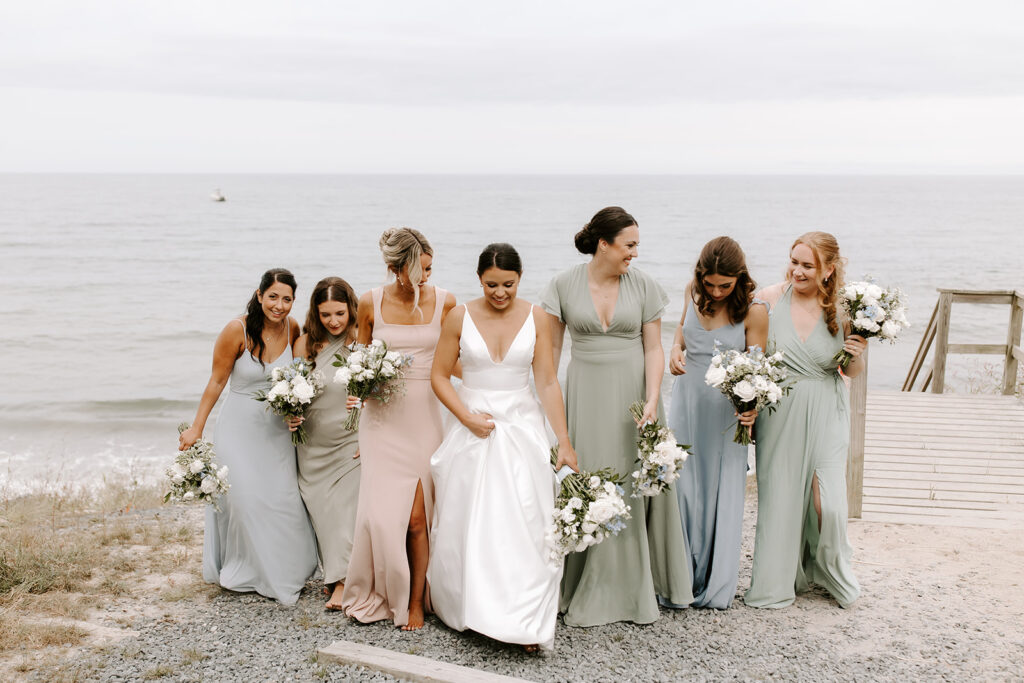 bridesmaids walking along the rocks