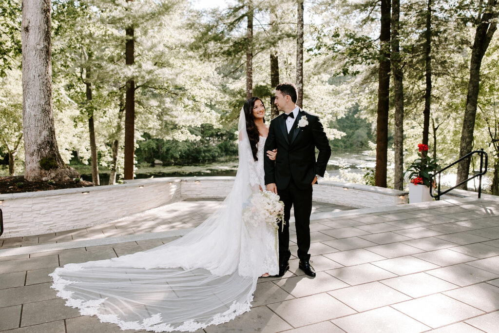 bride and groom posing in front of glowing sun