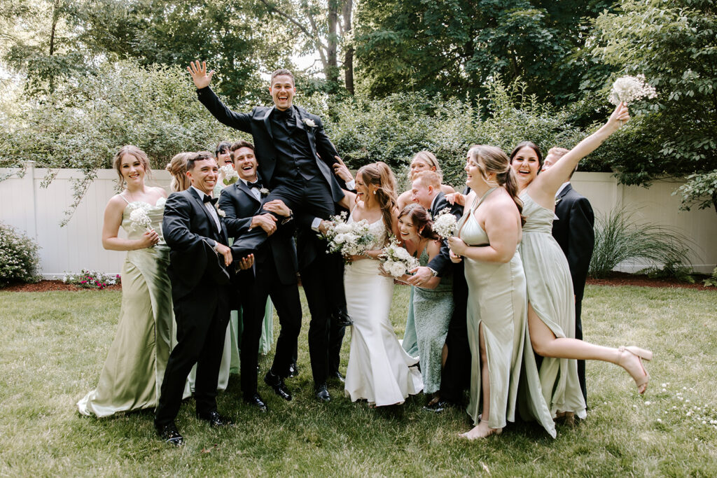 full wedding party laughing 