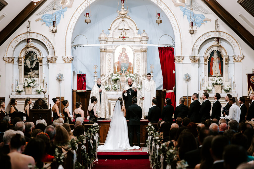 Wedding guests watching the couple’s sacred Armenian wedding ceremony at St. James Armenian Church