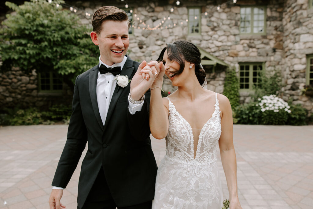 bride and groom laughing and walking