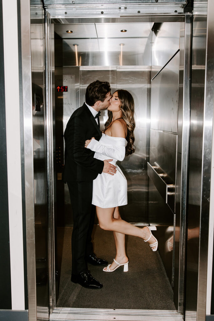 bride and groom kissing in elevator