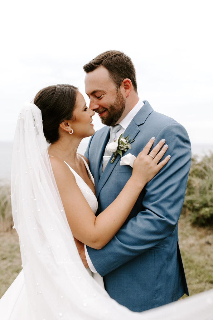 intimate moment with brides veil flowing in the wind