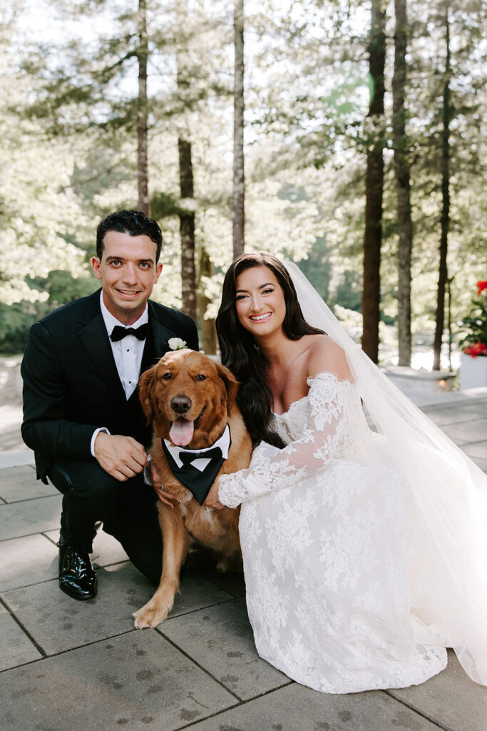Portrait of couple with Charlie the golden retriever wearing a bowtie