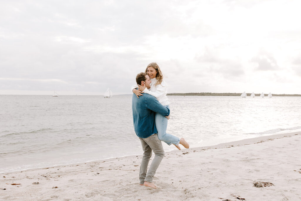 couple playing in the sand on a sunny day