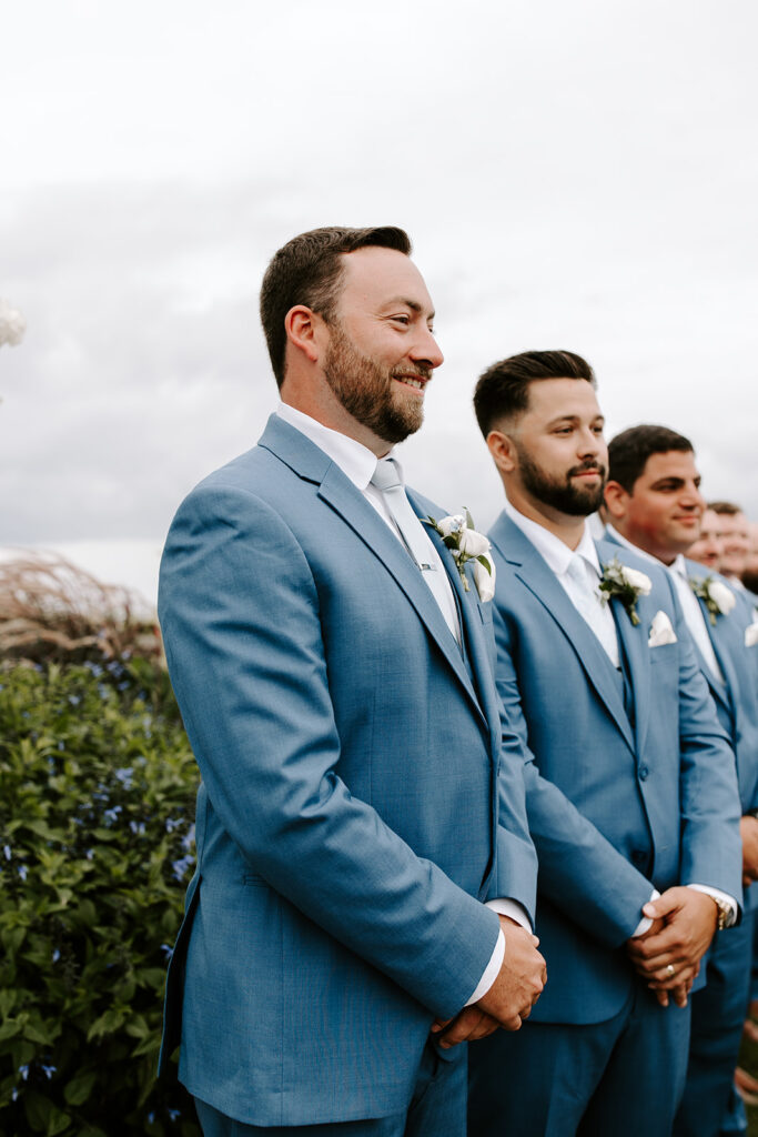 Groom smiling as he sees the bride for the first time