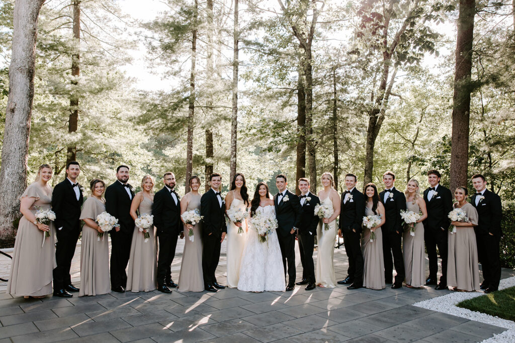 full wedding party with golden light behind them