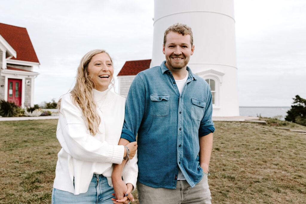 couple walking in front of cape cod lighthouse