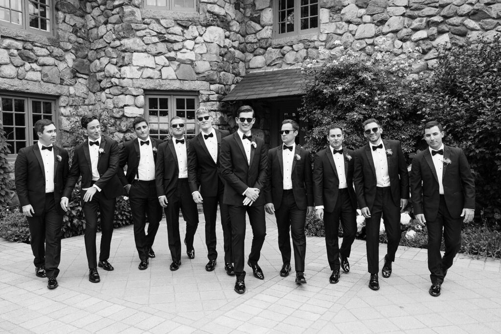groomsmen walking toward camera black tie