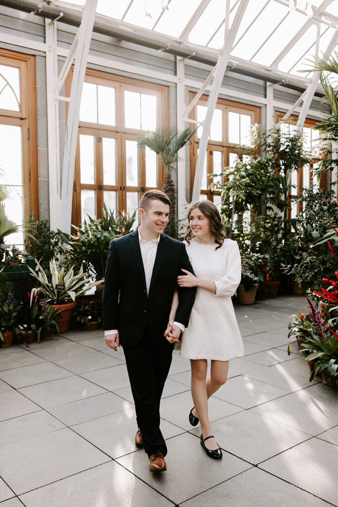 engagement photos walking through greenhouse