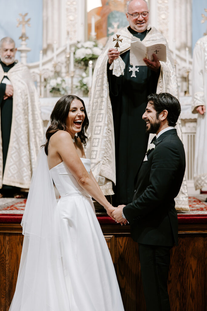 Bride and groom exchanging vows during their Armenian wedding ceremony at St. James Armenian Church in Watertown, MA.
