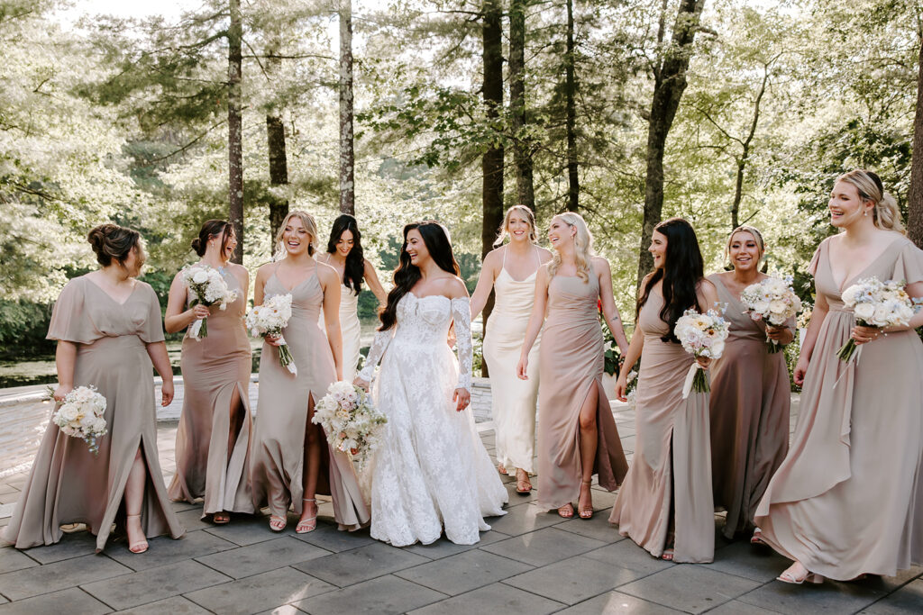 bridesmaids walking and smiling during golden hour