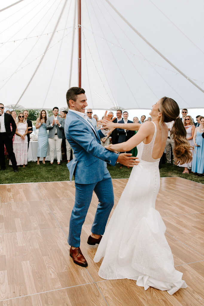 Bride and groom’s first dance under twinkling string lights at their Cape Cod backyard wedding reception