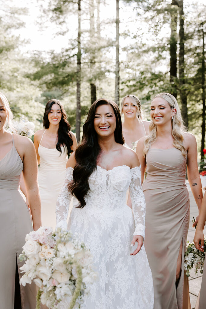 Bride laughing while holding bouquet of pastel florals
