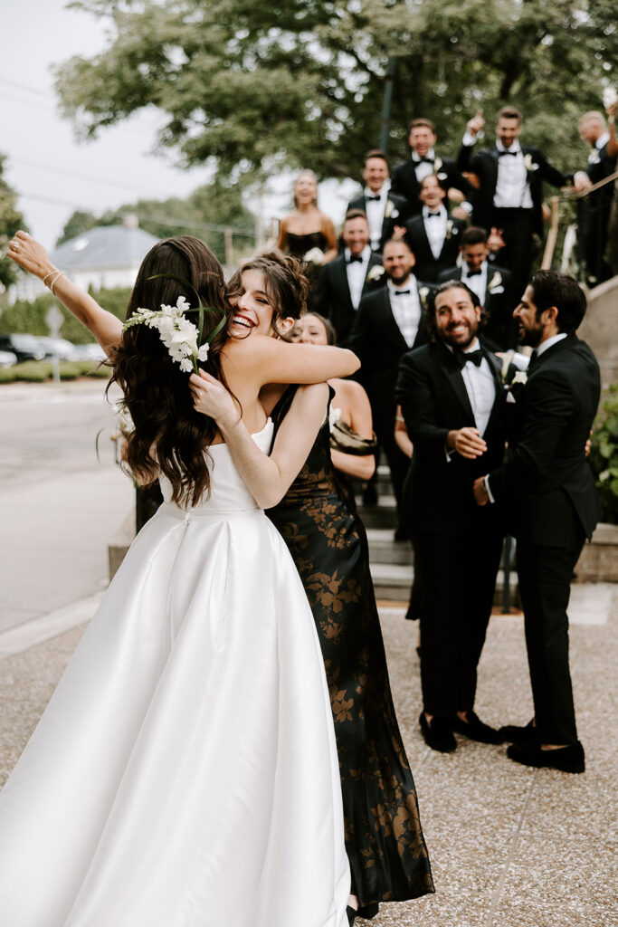 bridesmaid emotionally greeting bride after ceremony