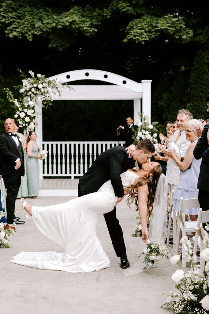 dip kiss as couple walks down aisle