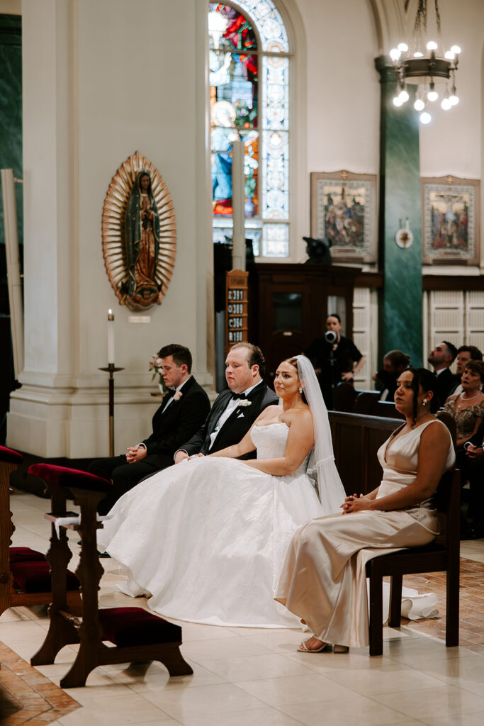 Bride and groom sitting during ceremony husband and wife at altar