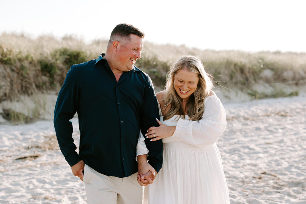 Couple walking barefoot along shoreline at Crane Beach