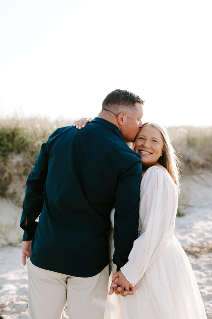 Romantic portrait with wind-blown hair and pastel sky

