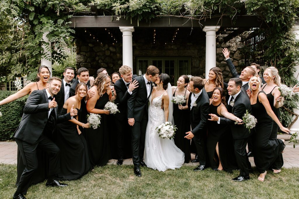 full wedding party partying around bride and groom