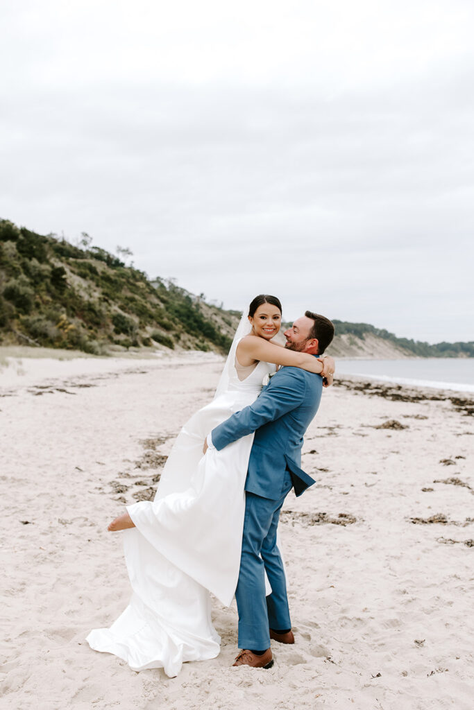 Groom spinning bride during a romantic moment at sunset