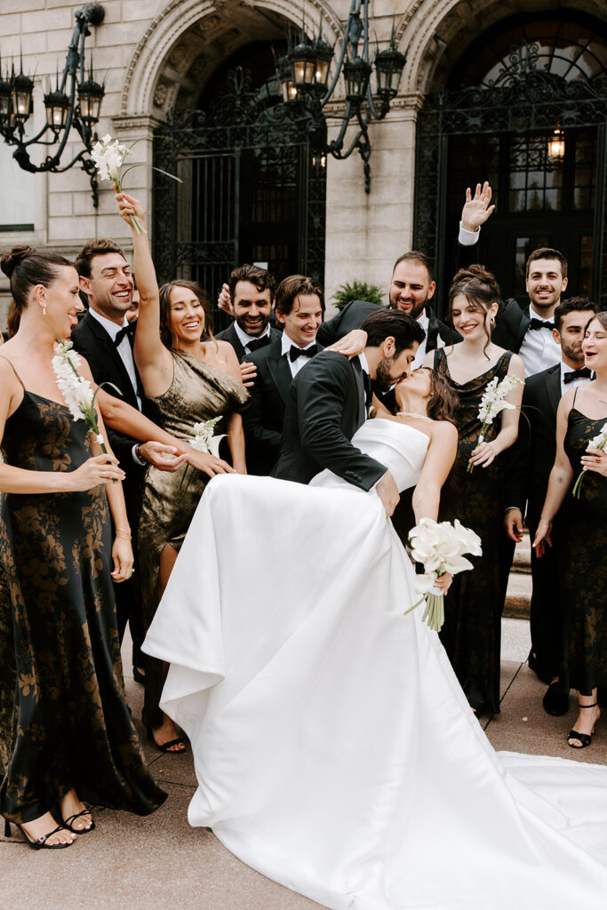 full wedding party surrounding newlyweds