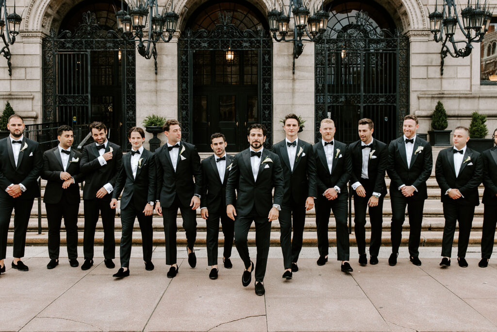 groomsmen walking outside of boston public libary