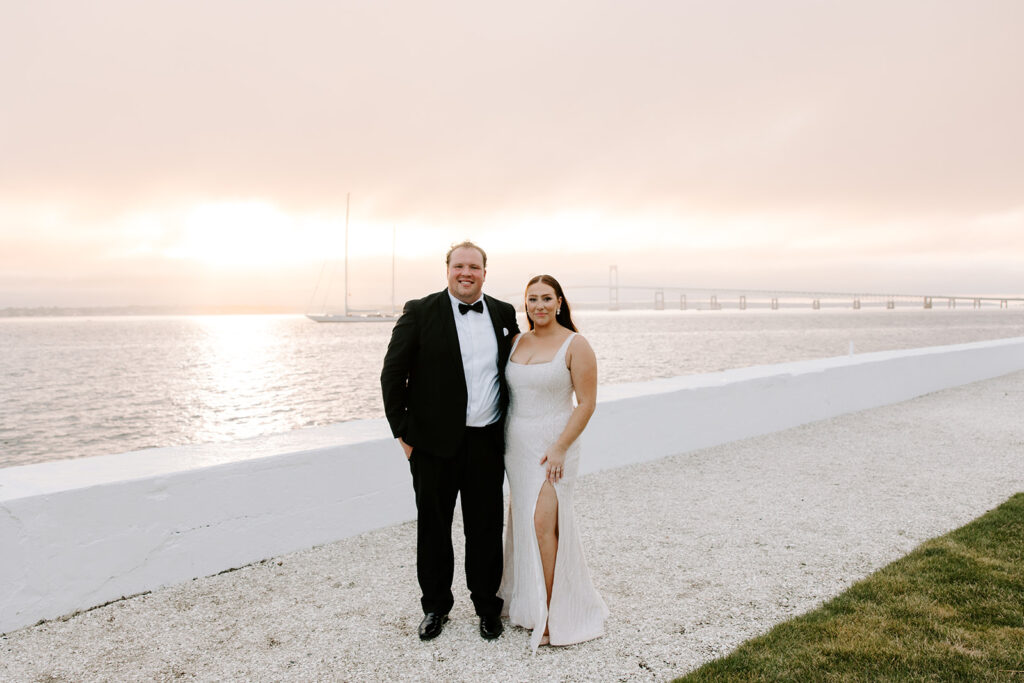 Sunset silhouette of couple on Belle Mer’s waterfront lawn
