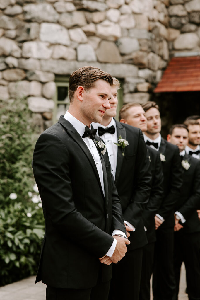 groom seeing bride walk down the aisle and getting emotional