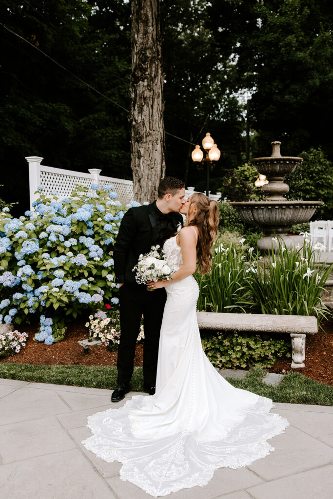 couple posing in lush gardens of saphire estate