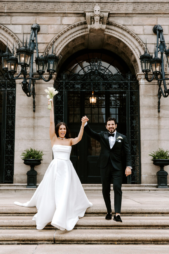bride and groom excitedly walking boston public library