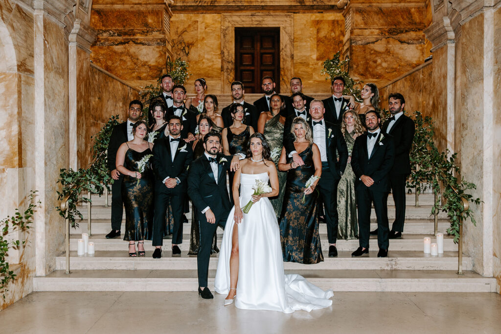 Wedding party posing on the grand marble staircase inside the Boston Public Library