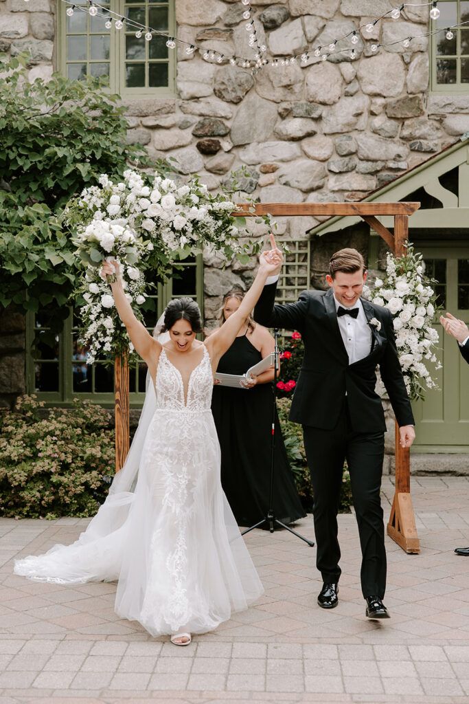 bride and groom joyfully about to walk down the aisle