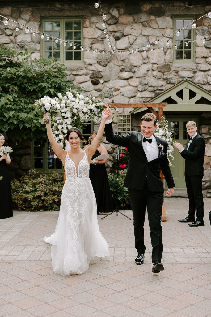 bride and groom walking down aisle as newlyweds