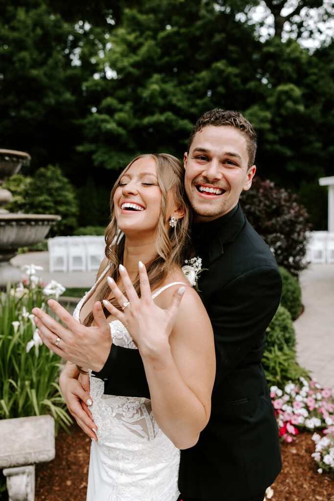 couple flexing their new rings post wedding