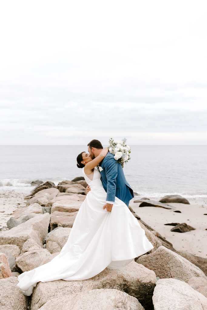 groom dipping bride on cliff