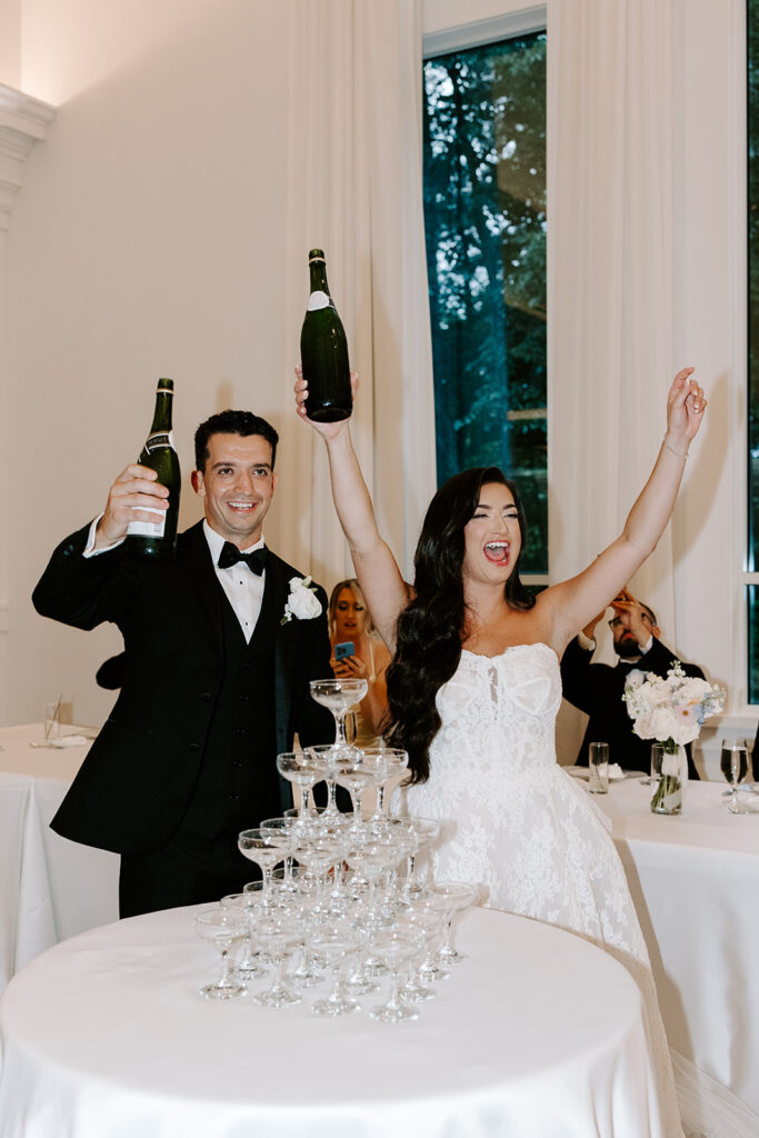 bride and groom celebrating with champagne tower