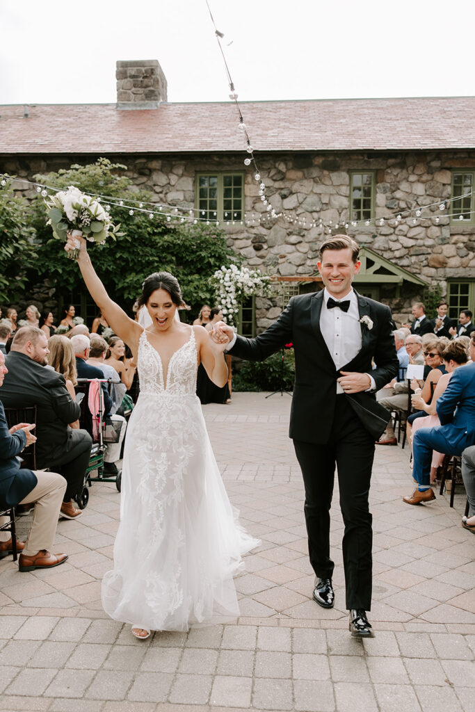 bride and groom joyfully walking down the aisle