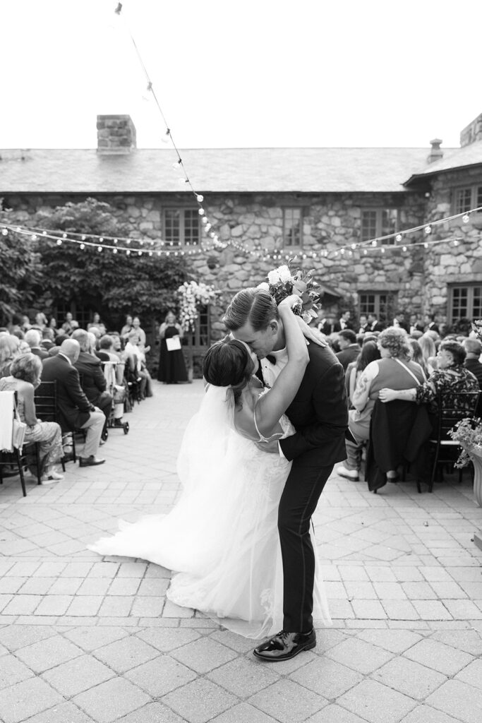 newlyweds kiss at the end of the aisle