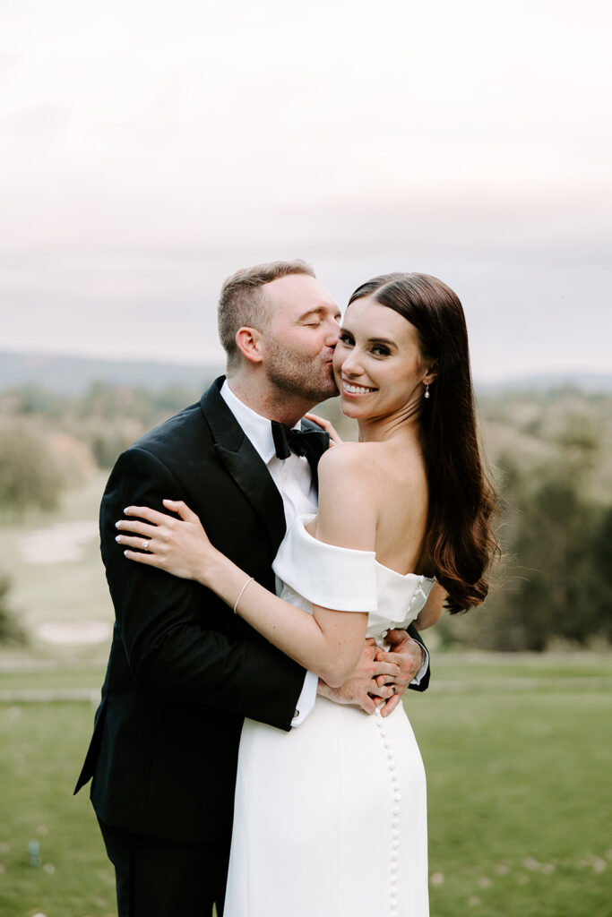 Soft light portrait of couple standing in front of glowing sky
