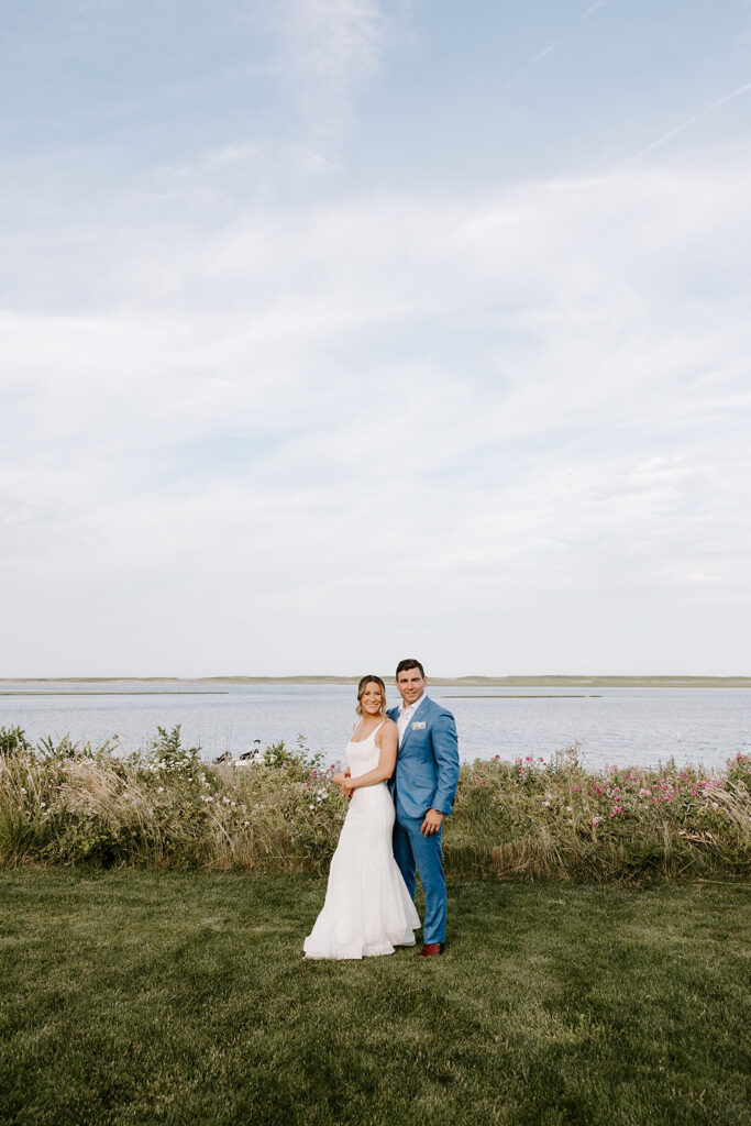 Dreamy golden hour wedding portrait with soft, warm light highlighting the bride and groom.
