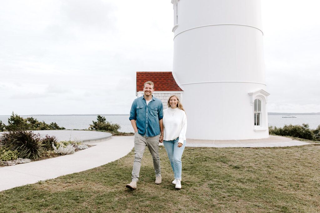 Romantic engagement photo in front of iconic Cape Cod lighthouse