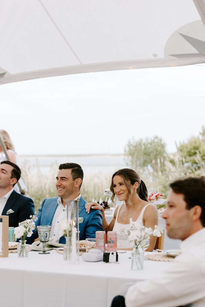 bride and groom listening to speeches