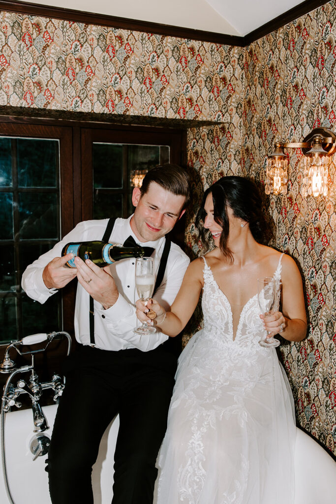 bride and groom sharing a glass of champagne in willowdale bathtub