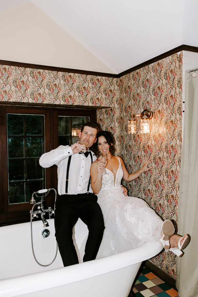 newlyweds popping champagne in bathrub
