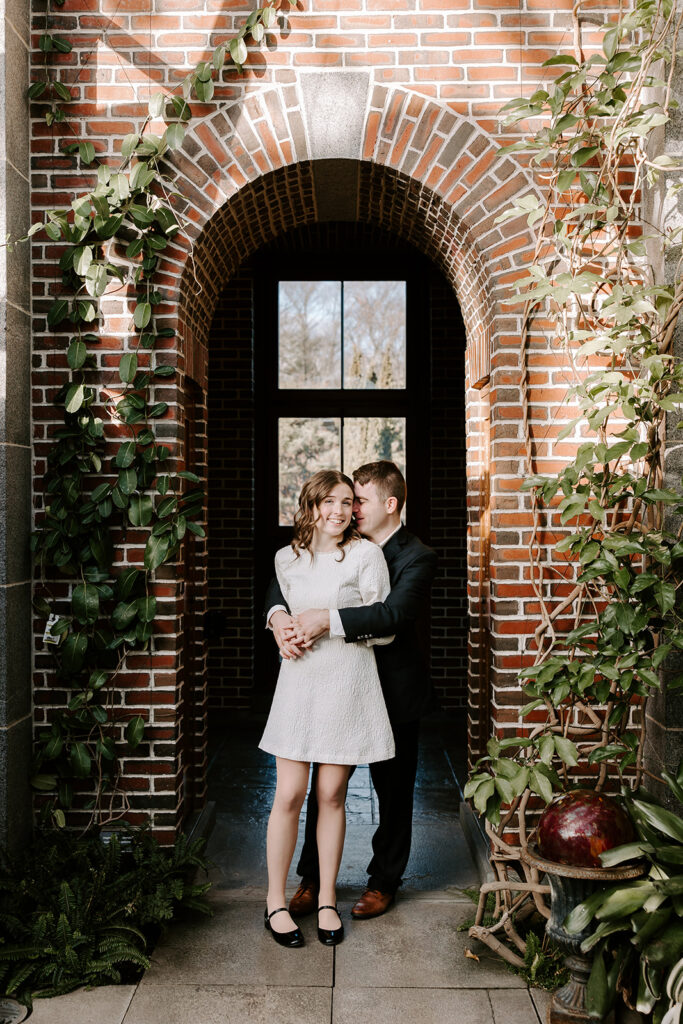Engagement portrait with greenhouse greenery and natural filtered light