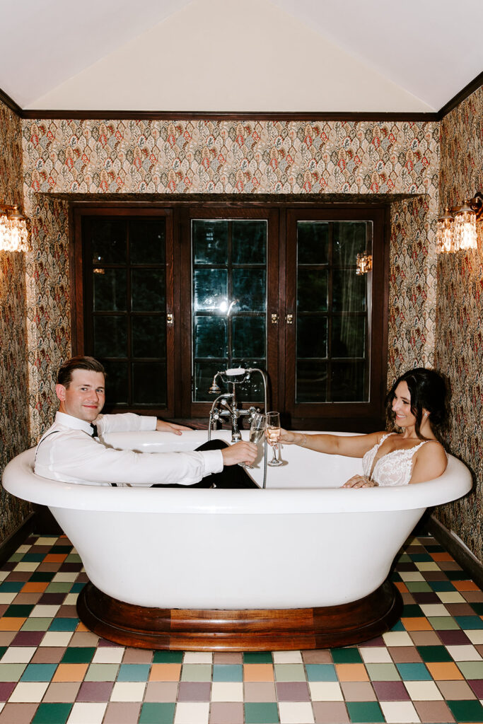 bride and groom celebrating newlywed bliss in vintage bathrub