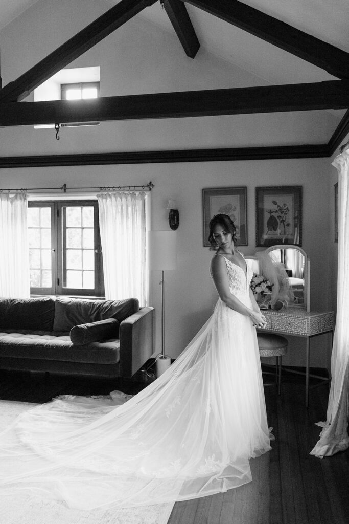 bride in window of willowdale estate getting ready